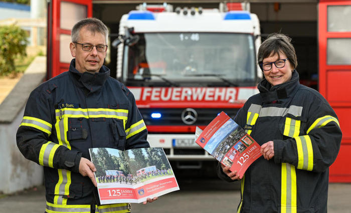 Wehrführer Ralf Stahl und die Erste Vorsitzende der Freiwilligen Feuerwehr, Birgit Willems, präsentieren die Festschrift. FOTO: PRIVAT